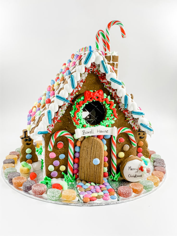 signature gingerbread house with candy cane door and chimney