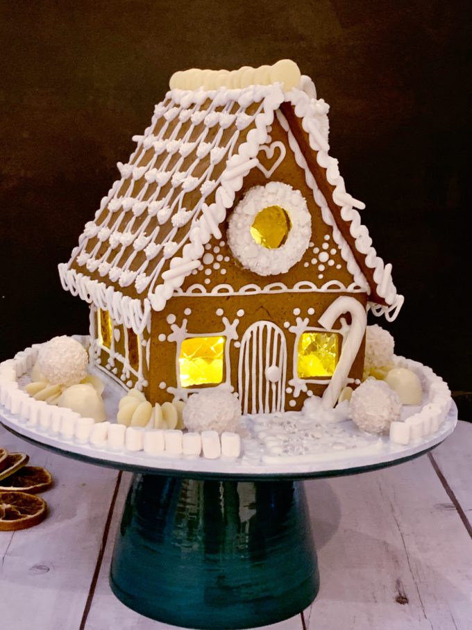 smaller white house with brown gingerbread showing