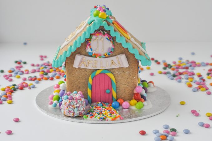 Birthday gingerbread cottage decorated in bright colours