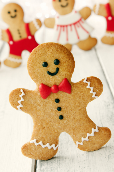 Dancing gingerbread man with gingerbread people in the background