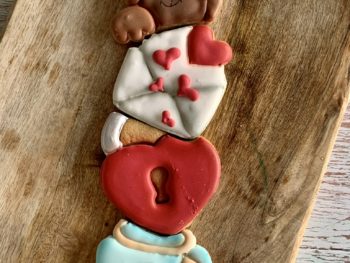valentines cookie tower gift set comprising of a teddy a letter with hearts, a heart padlock and a jar of hearts in blue