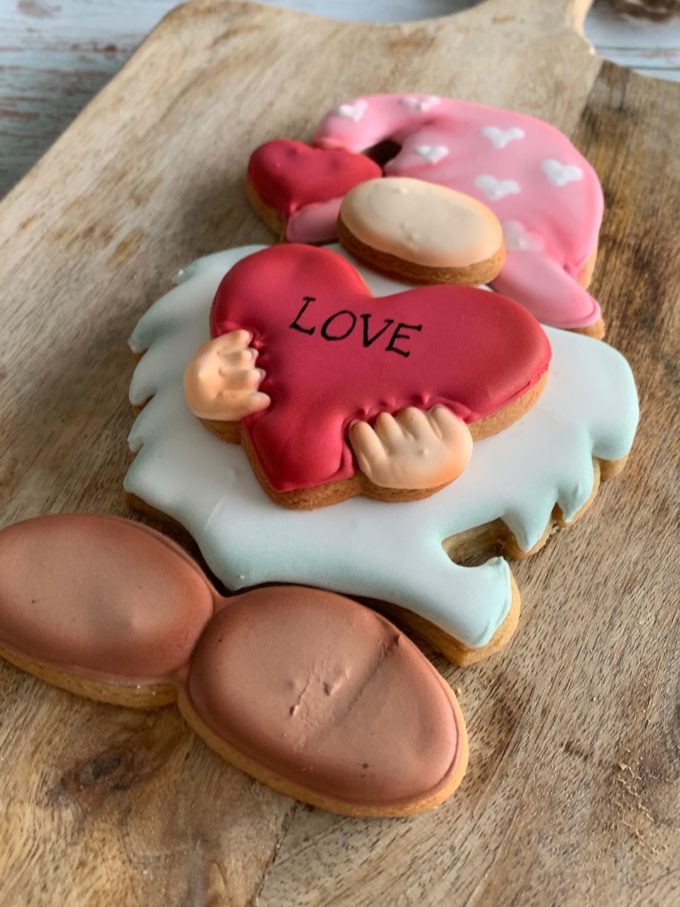 Gnome ginger biscuit cookie puzzle with pink hat, white beard and red heart saying love on the front